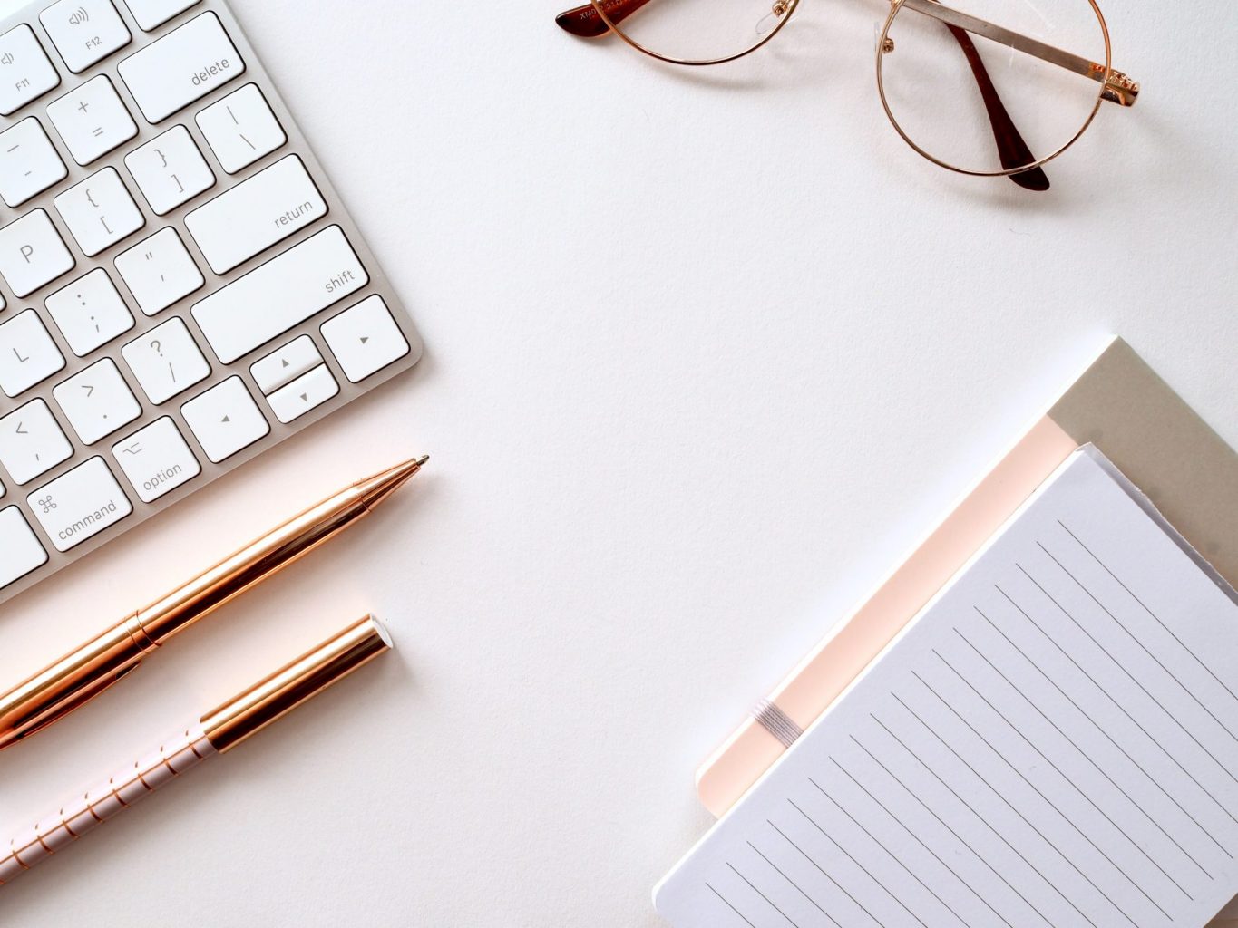 keyboard with notebooks and glasses
